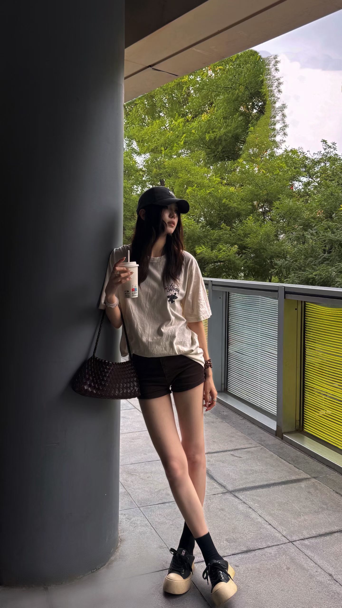 Source image for Cinematic Portrait of Woman Leaning on Pillar with Coffee Cup