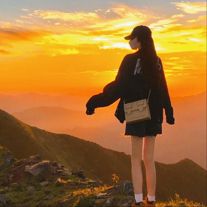 Source image for Hiker Silhouetted Against Golden Sunset on Mountain Ridge