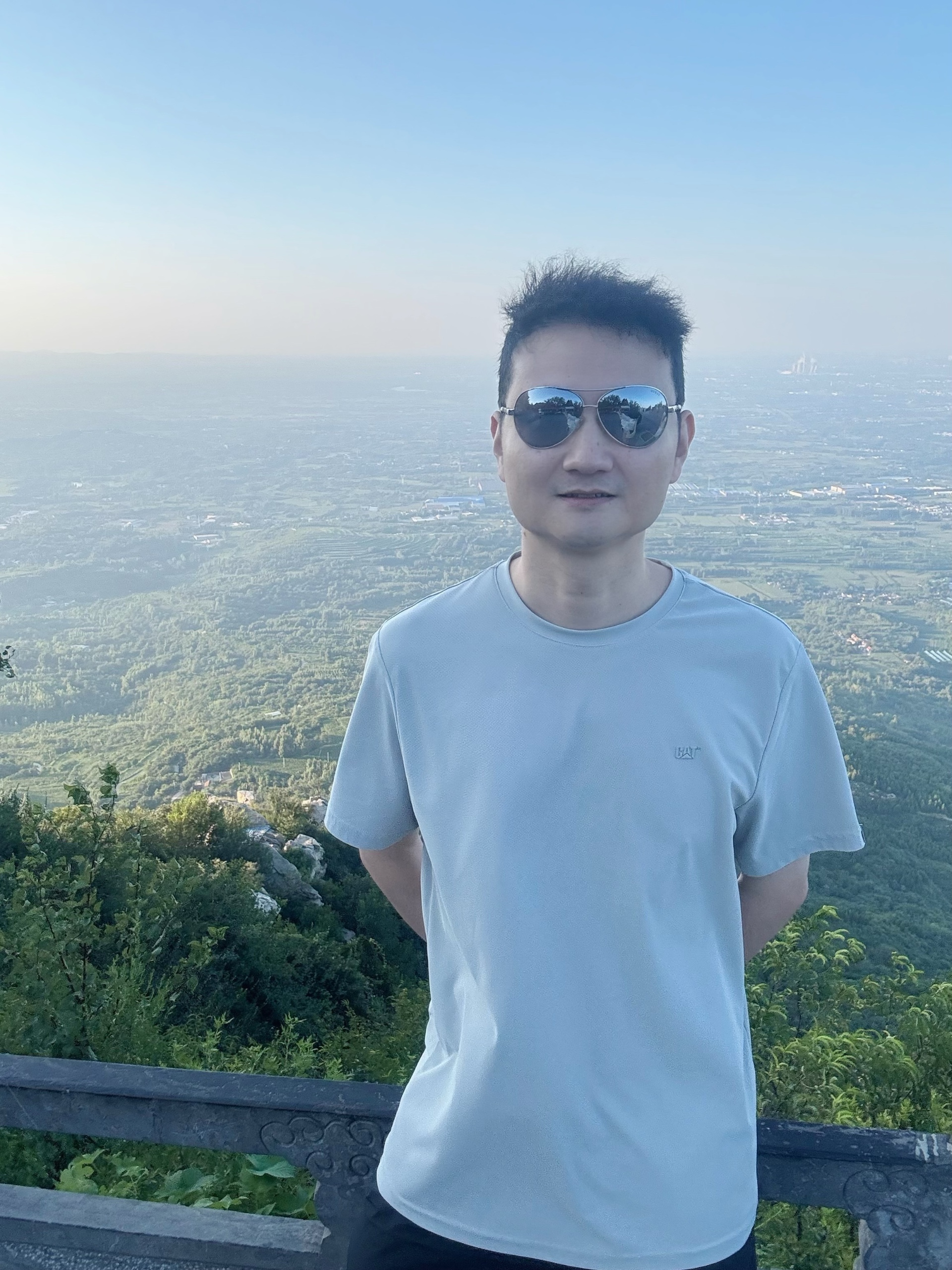 Source image for Cool Guy Poses on Mountain Overlook with Hazy Valley View