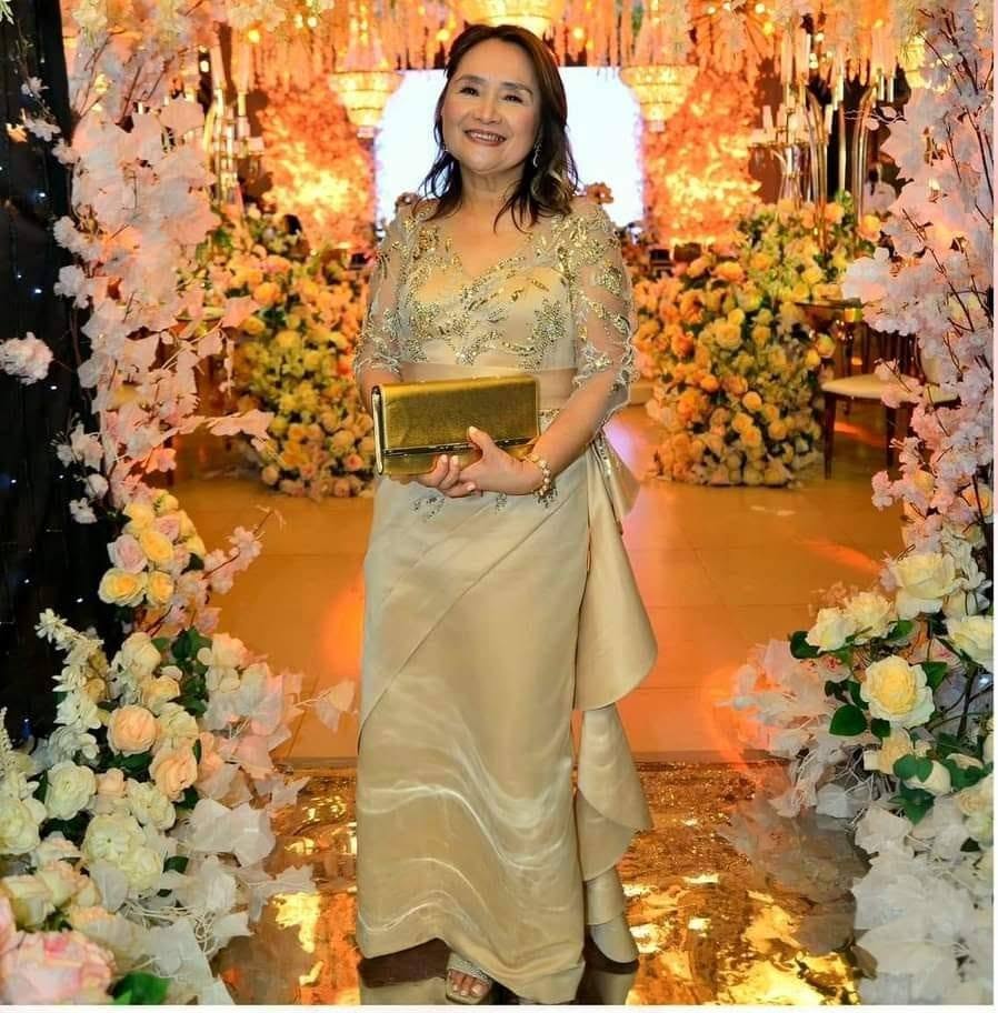 Source image for Elegant Woman Poses Without Clutch at Floral Event