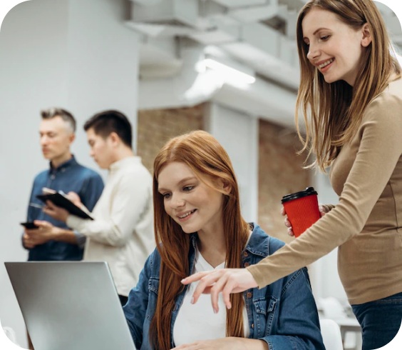 Source image for Collaborative Office Moment Redhead and Colleague Reviewing Laptop Screen