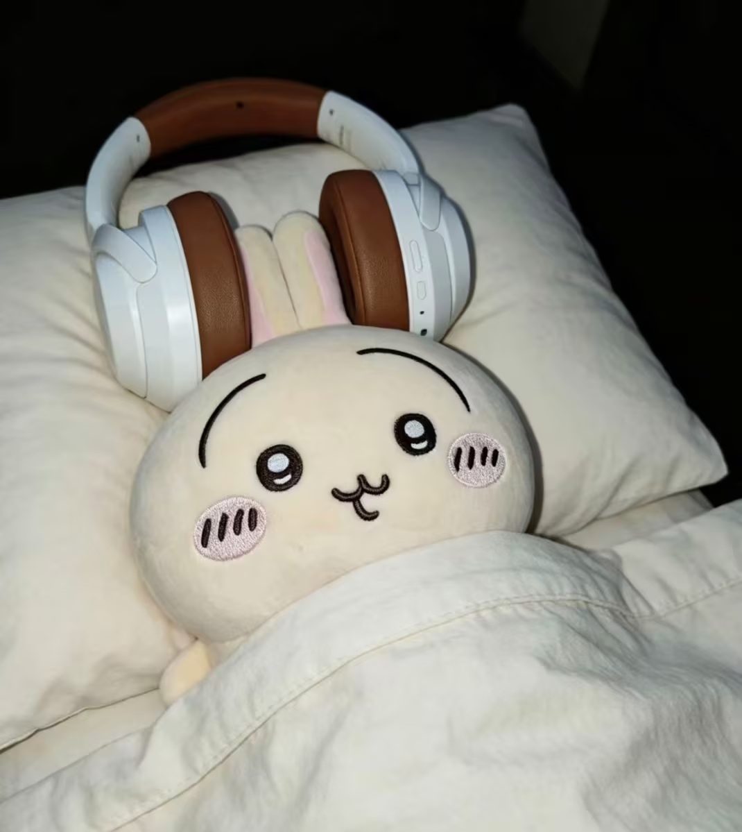 Source image for Cute Plush Rabbit Wearing Headphones Tucked Into Bed