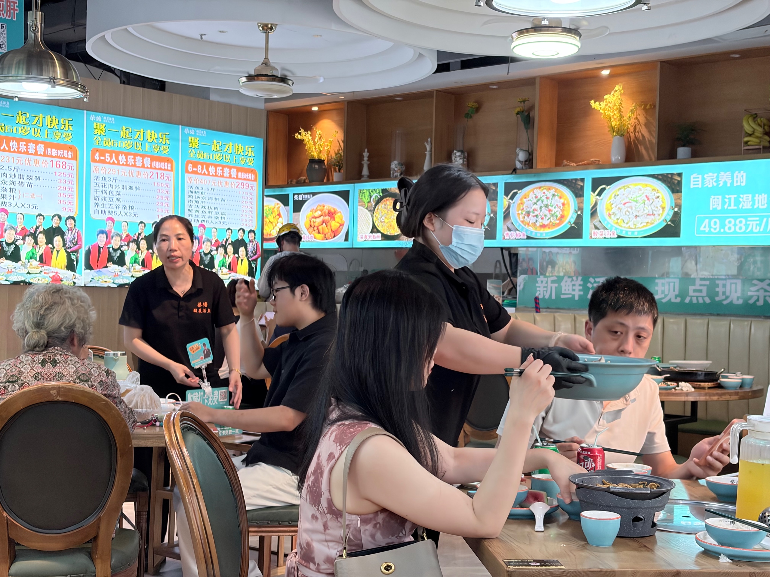 Source image for Waitress Serving Large Blue Bowl to Diners in Busy Restaurant