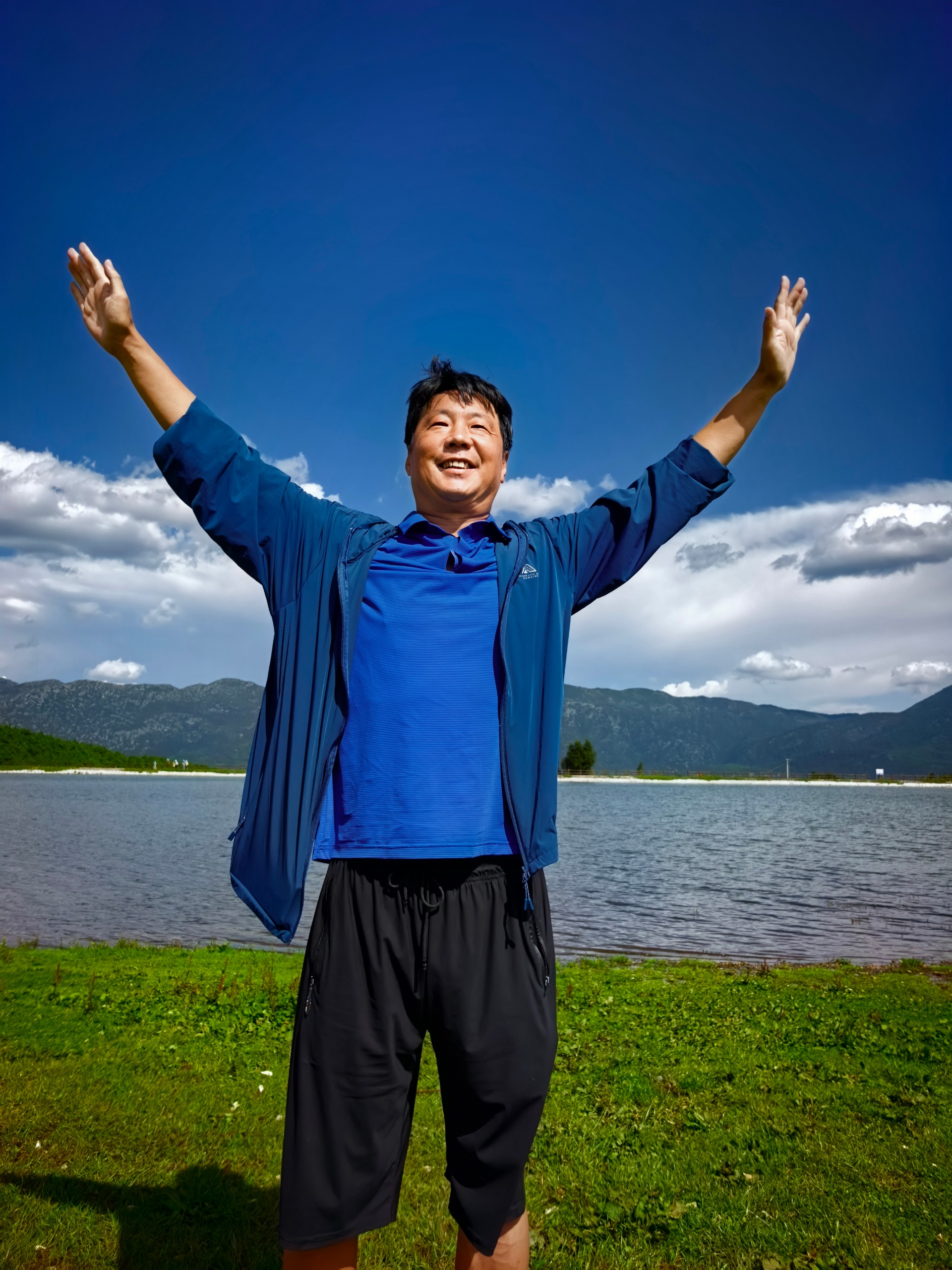 Source image for Man in Blue Jacket Performs Comedic Hip Dance by the Lake