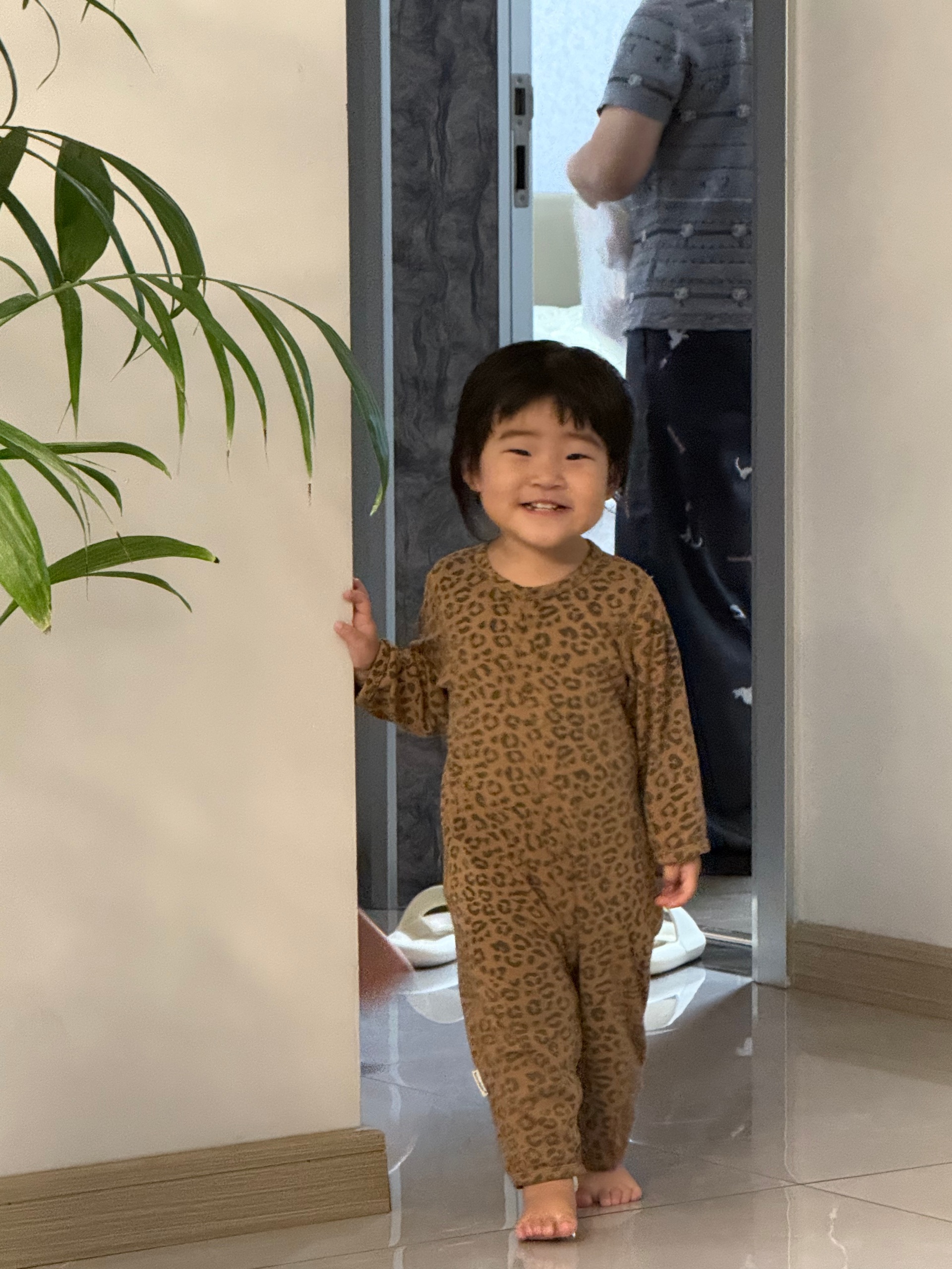 Source image for Toddler in Leopard Pajamas Takes a Confident Step Forward
