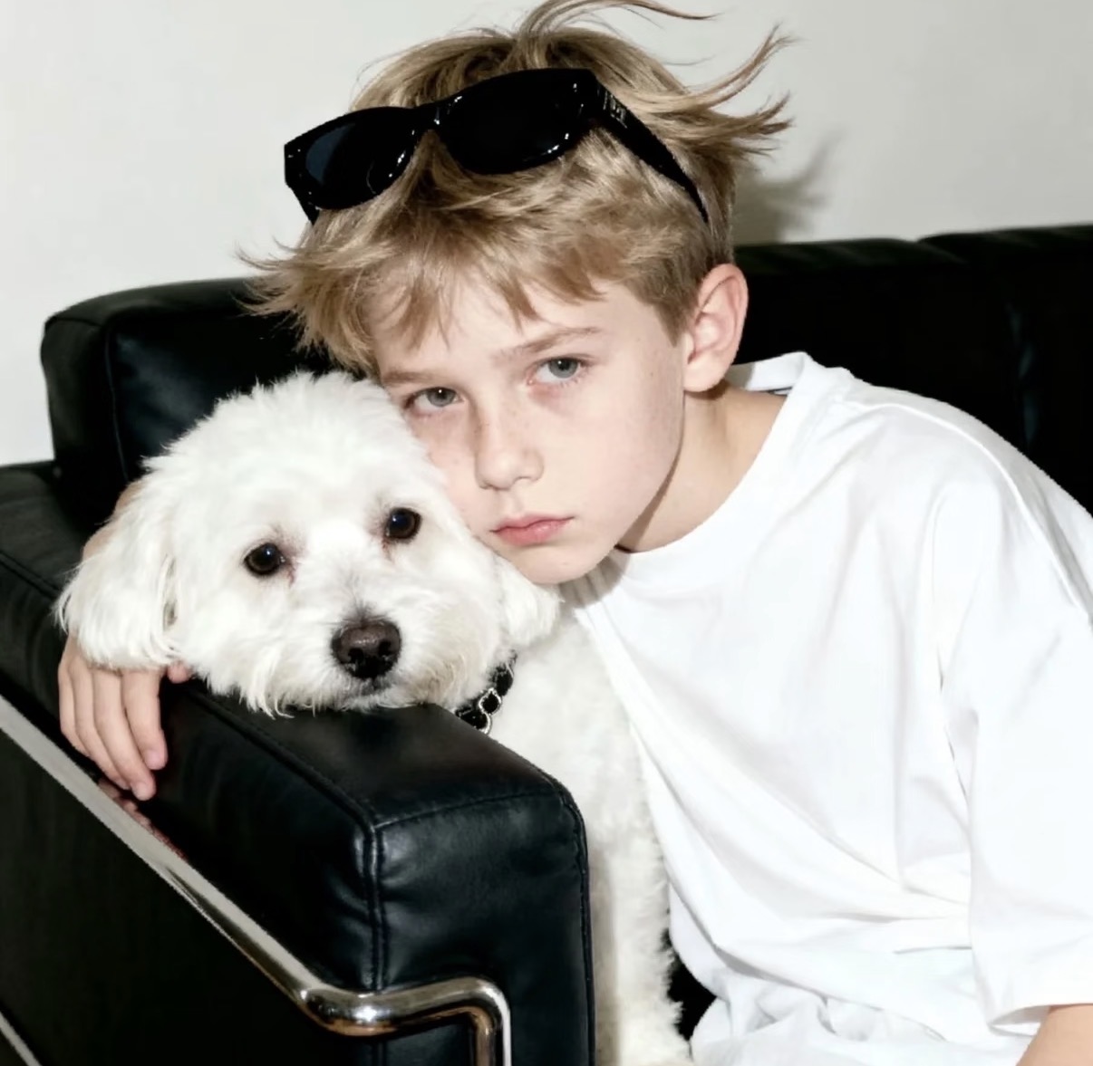 Source image for Cool Boy and White Dog Pose on Black Leather Sofa