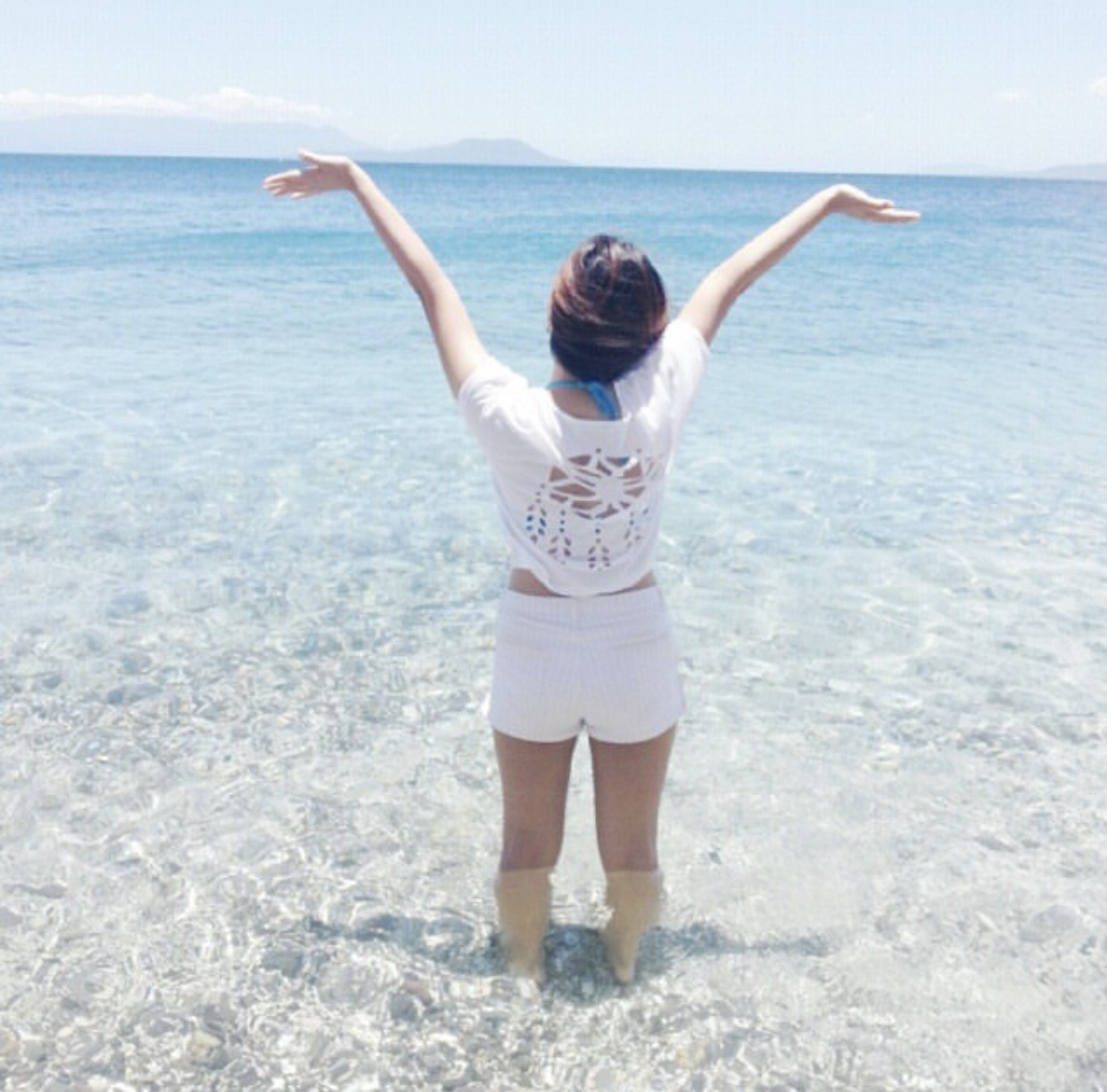 Source image for Woman Turns Around in Shallow Water to Face Camera Full Body Shot