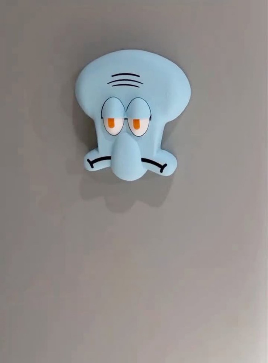 Source image for Annoyed Blue Cartoon Head Stuck to Wall Wobbles