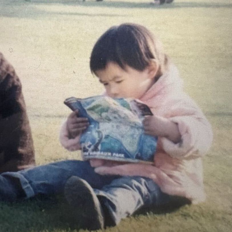 Source image for Toddler Intently Examining Zoo Map on the Grass