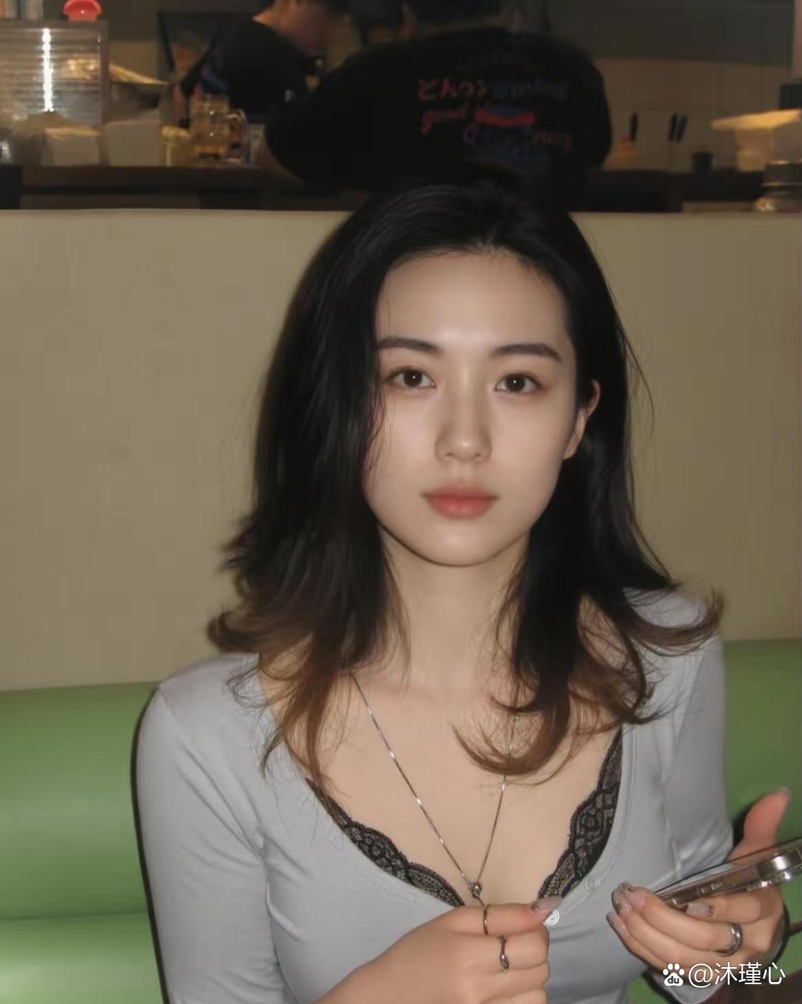 Source image for Woman in Grey Top Reacts to Phone with Comedic Blink and Hair Toss