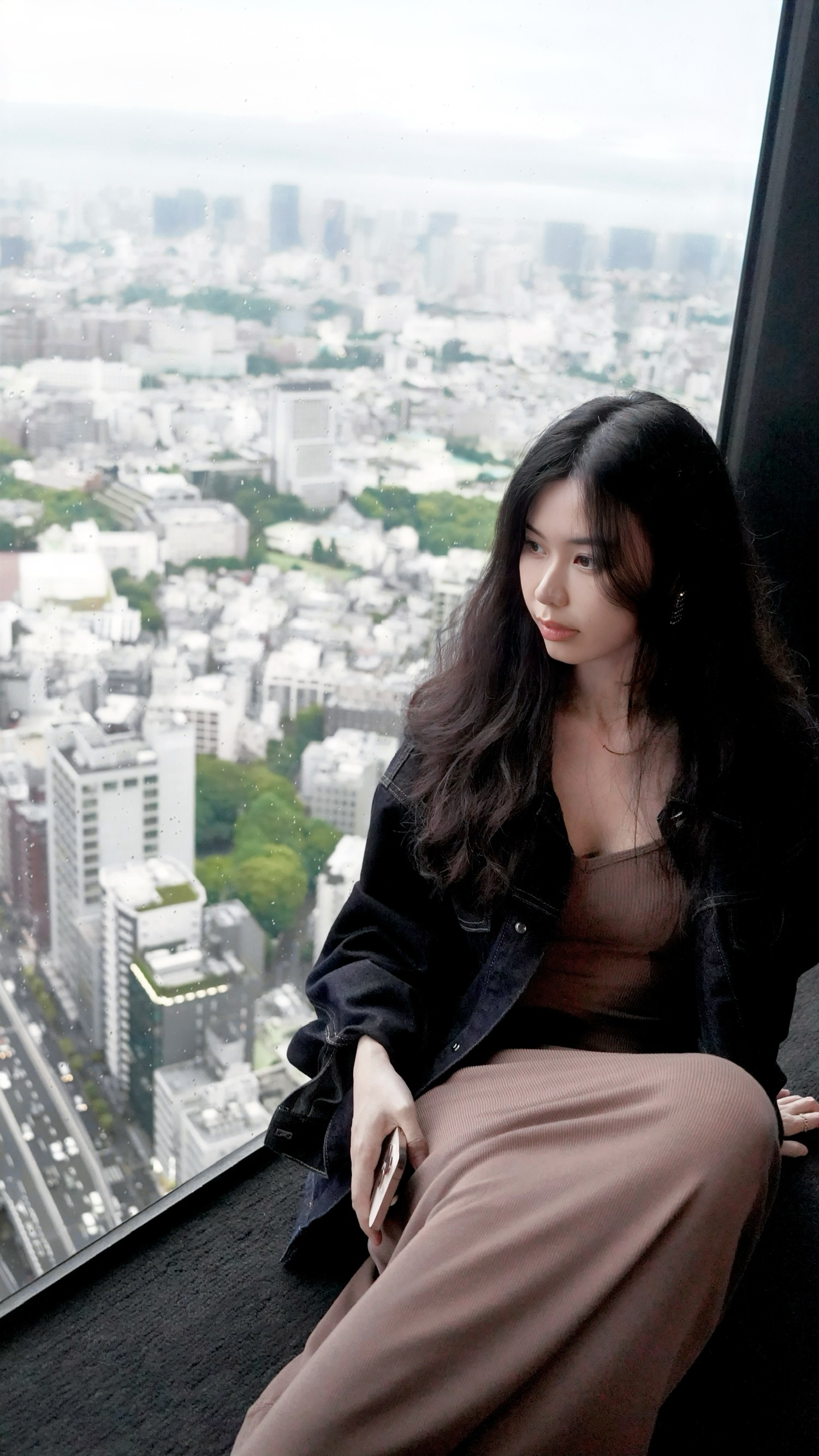 Source image for Woman Stretching and Gazing Out Over Hazy City Skyline